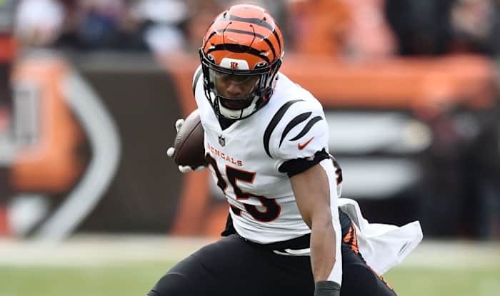 Jan 9, 2022; Cleveland, Ohio, USA; Cincinnati Bengals running back Chris Evans (25) leaps over Cleveland Browns cornerback A.J. Green (38) during the first quarter at FirstEnergy Stadium. Mandatory Credit: Ken Blaze-USA TODAY Sports